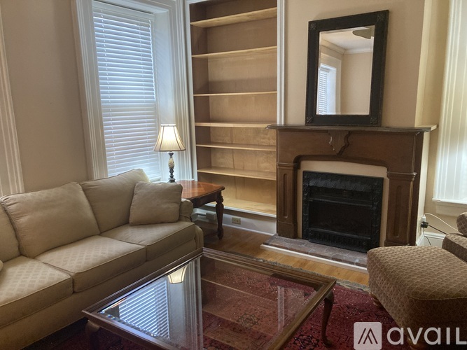 A living room with a fireplace, a couch, and a coffee table.