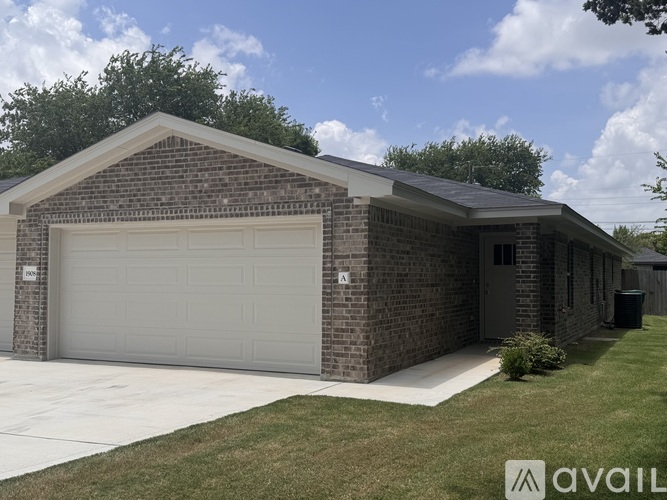 A two-car garage with a brick exterior and a white door.