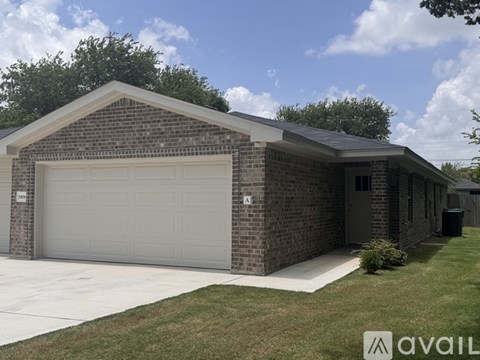 A two-car garage with a brick exterior and a white door.