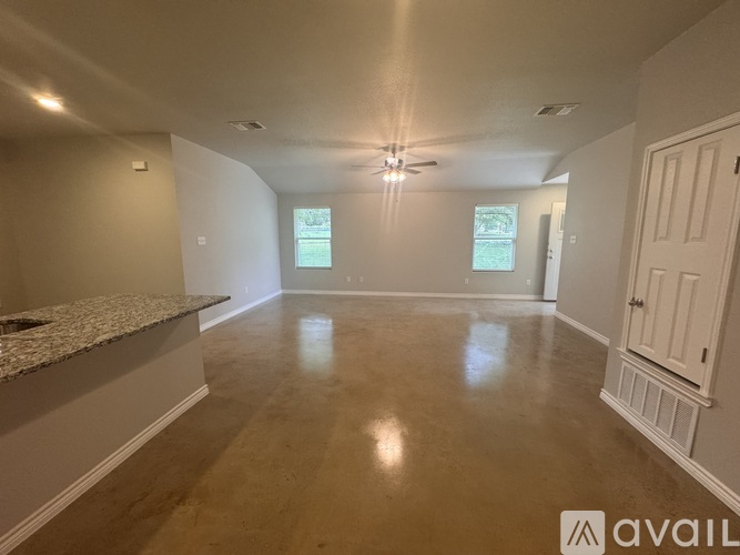 A spacious room with a marble countertop and a window.