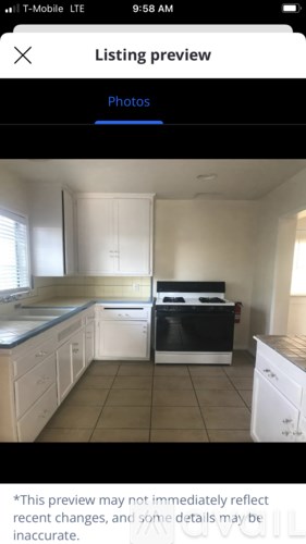A kitchen with white cabinets and a black stove top oven.