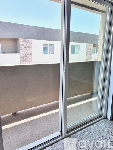 A glass door with a reflection of a building.