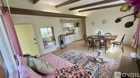 A living room with a dining table and chairs.