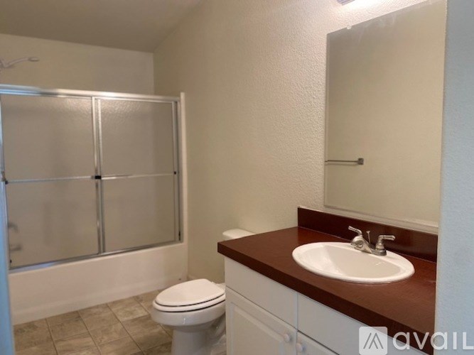A bathroom with a toilet, sink, and shower.