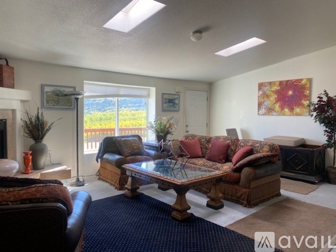 A living room with a couch, chair, and coffee table.