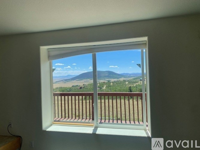 A window with a view of a mountain and sky.
