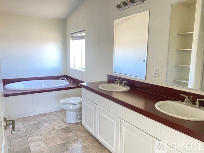 A bathroom with a tub, toilet, and sink.