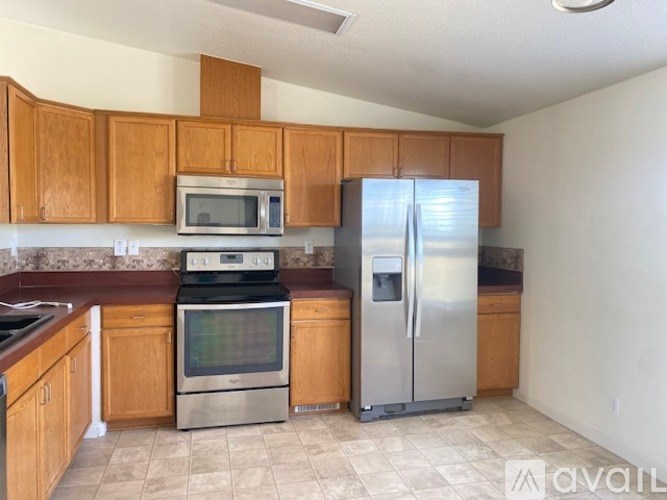 A kitchen with wooden cabinets and stainless steel appliances.