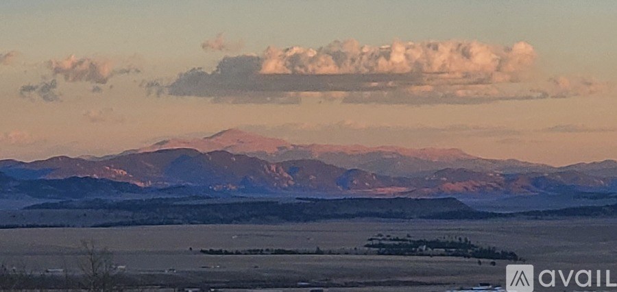 A mountain range stretches across the horizon under a cloudy sky.