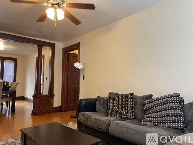 A living room with a grey couch and a wooden coffee table.