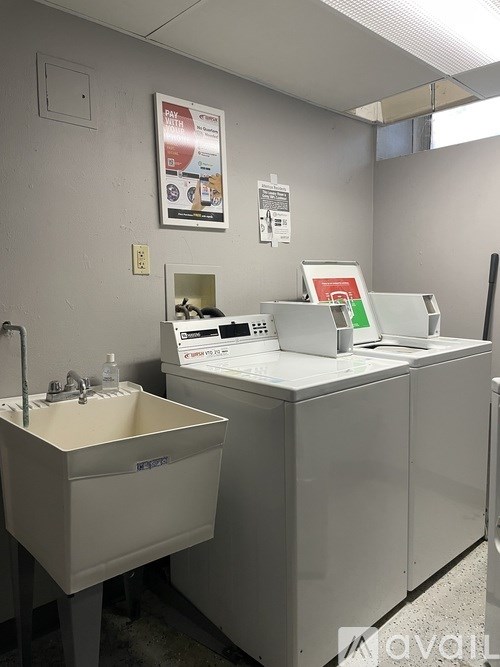 A bathroom with a sink and a toilet paper dispenser.