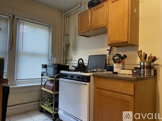 A kitchen with wooden cabinets and a white oven.