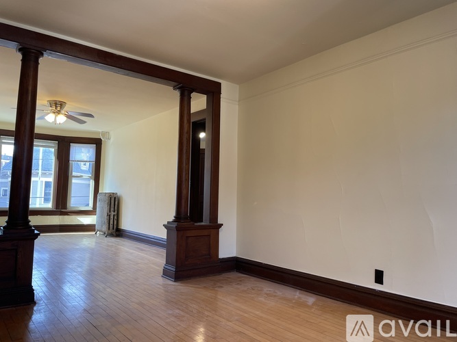 A living room with a grey couch and a wooden coffee table.