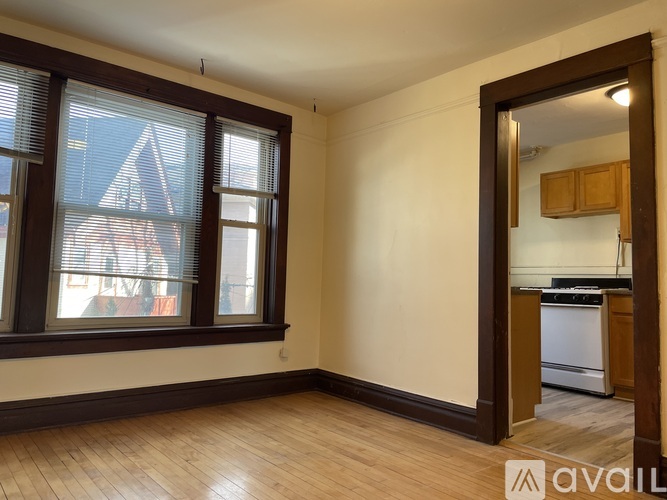 A kitchen with brown cabinets and a white dishwasher.