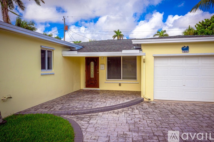 A house with a yellow exterior and a white garage door.
