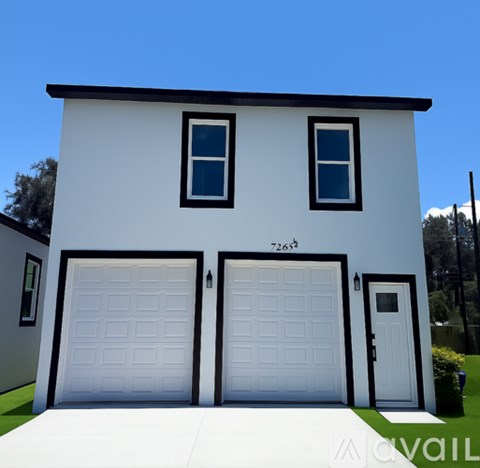A two-story house with a white exterior and black trim.