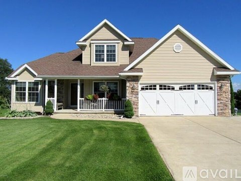 A two-story house with a garage and a front porch.