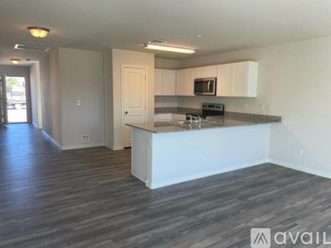 A kitchen with a countertop and a microwave.