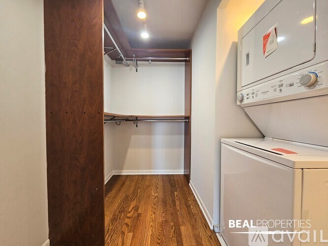 A BEALPROPERTIES sign is on a wall above a white oven.