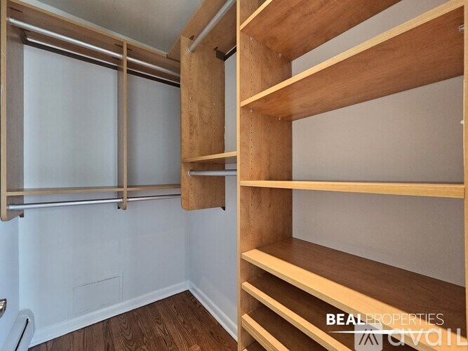 A white wall with a shelf and a window.