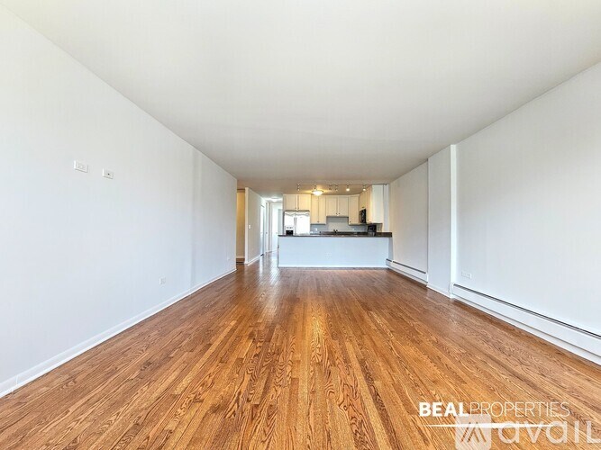 A white shelving unit with a metal frame and a white door is in a room with white walls.