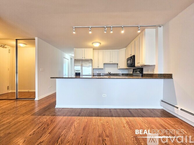 A hallway with a white door and a white wall.