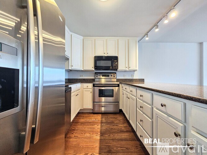 A room with a window overlooking a cityscape is available for rent.