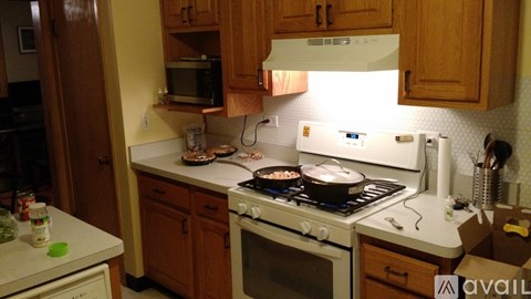 A kitchen with a stove top oven and a microwave.