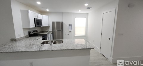 A kitchen with granite countertops and stainless steel appliances.