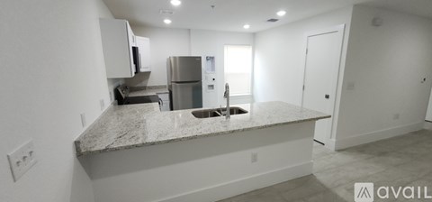 A kitchen with granite countertops and stainless steel appliances.
