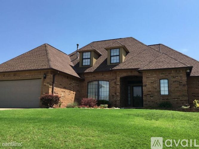 A house with a brown roof and a garage door.
