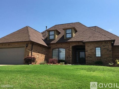 A house with a brown roof and a garage door.