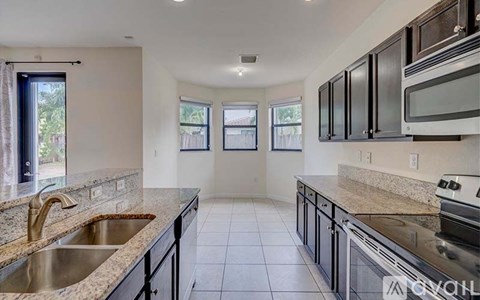 A kitchen with granite countertops and stainless steel appliances.