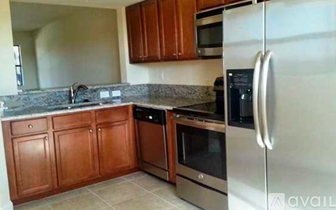 A kitchen with wooden cabinets and stainless steel appliances.