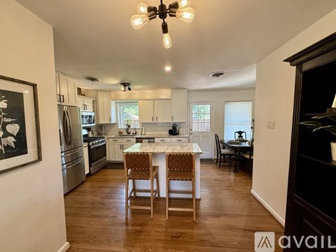A kitchen with a table and chairs in the middle of the room.