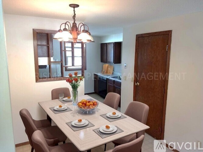 A dining room with a table set for six people.