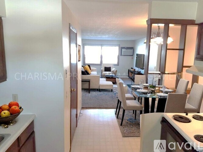 A kitchen with a bowl of apples on the counter.