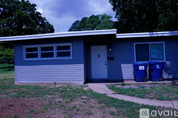 A blue house with a white door and windows.