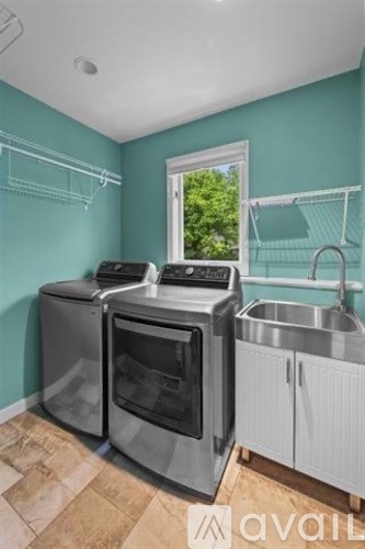 A kitchen with a stainless steel oven and sink.
