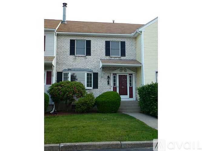 A house with a red door and a white wall.