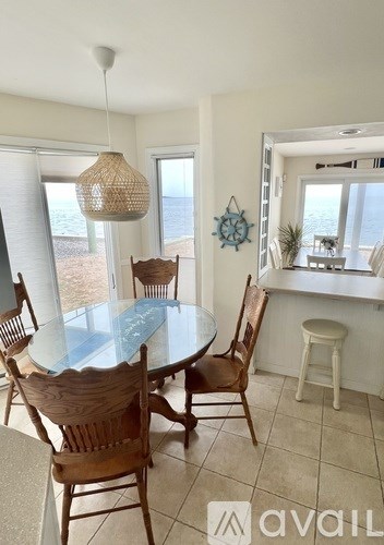 A dining room with a glass table and chairs.