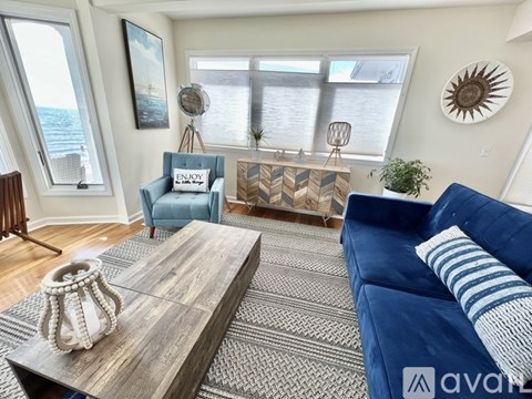 A living room with a blue couch and a wooden coffee table.