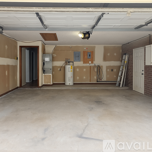 A spacious garage with a concrete floor and walls under construction.