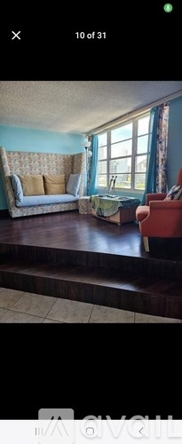 A living room with a couch, a chair, and a table.