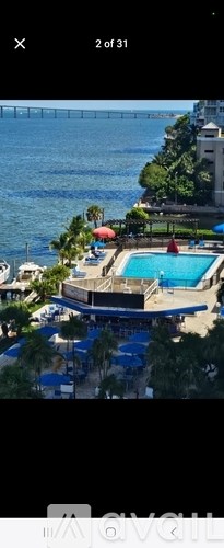 A view of a pool area with a bridge in the background.