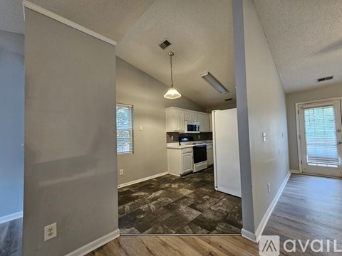 A kitchen with a refrigerator, oven, and sink is available for rent.
