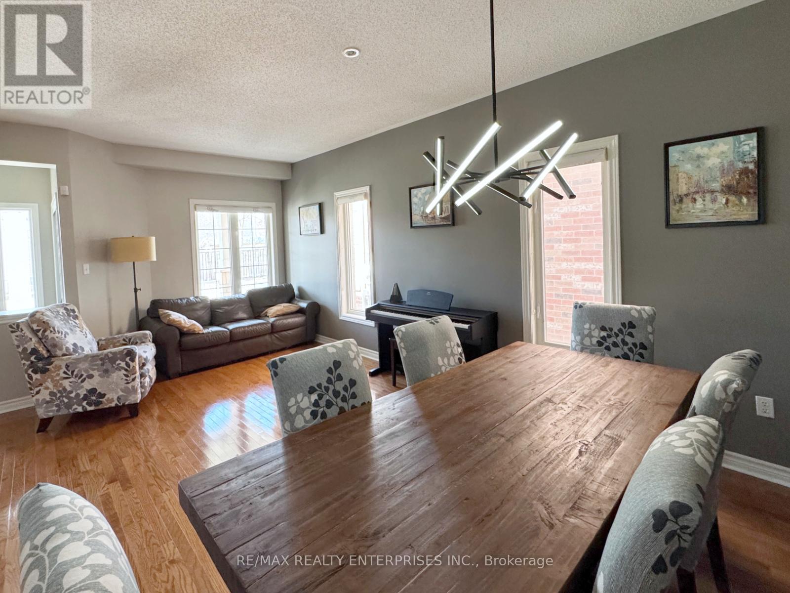A dining room with a wooden table and chairs.
