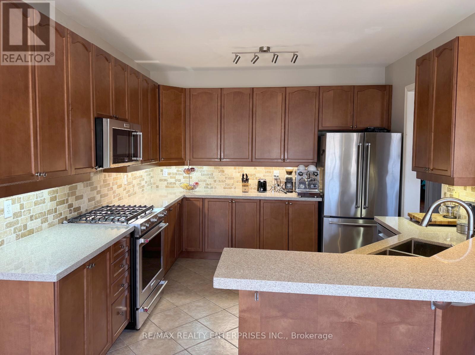 A kitchen with brown cabinets and a white countertop.