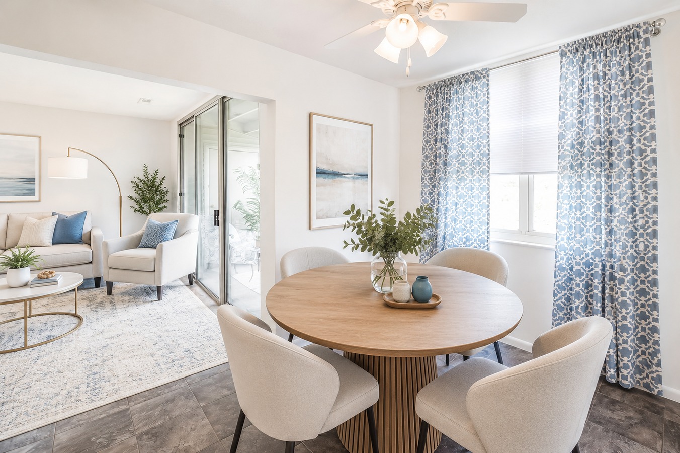 A dining room with a round table and chairs.