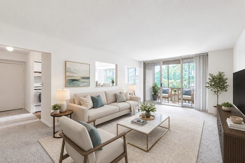A living room with a white sofa, a coffee table, and a painting on the wall.